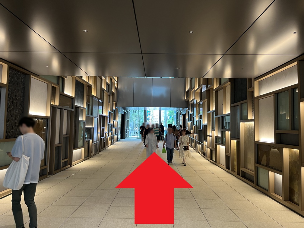 Turn left at the first corner, then continue straight ahead until you reach the outdoors.